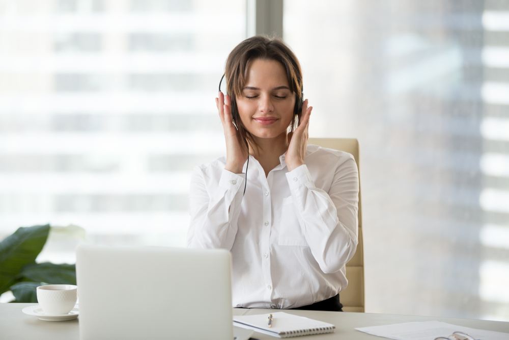 Woman relaxing listening to radio at work hygge